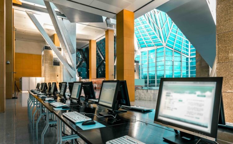 An interior of a modern spacious computer room in a library or office