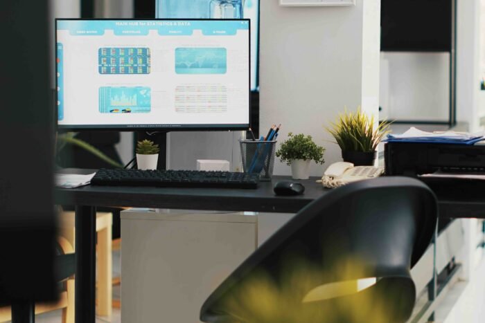 Empty company financial department with stock portfolio on computer monitor containing collection of investment assets. Workspace with live index indices on PC screen showing stock demand surge